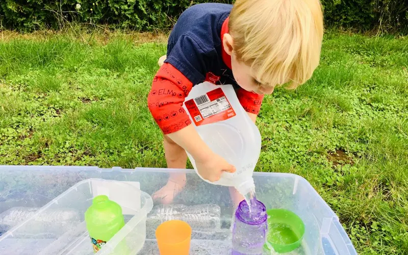 Benefits of Sand and Water Play: How It Boosts Child Development 5 kids pouring water measuring cups preschool